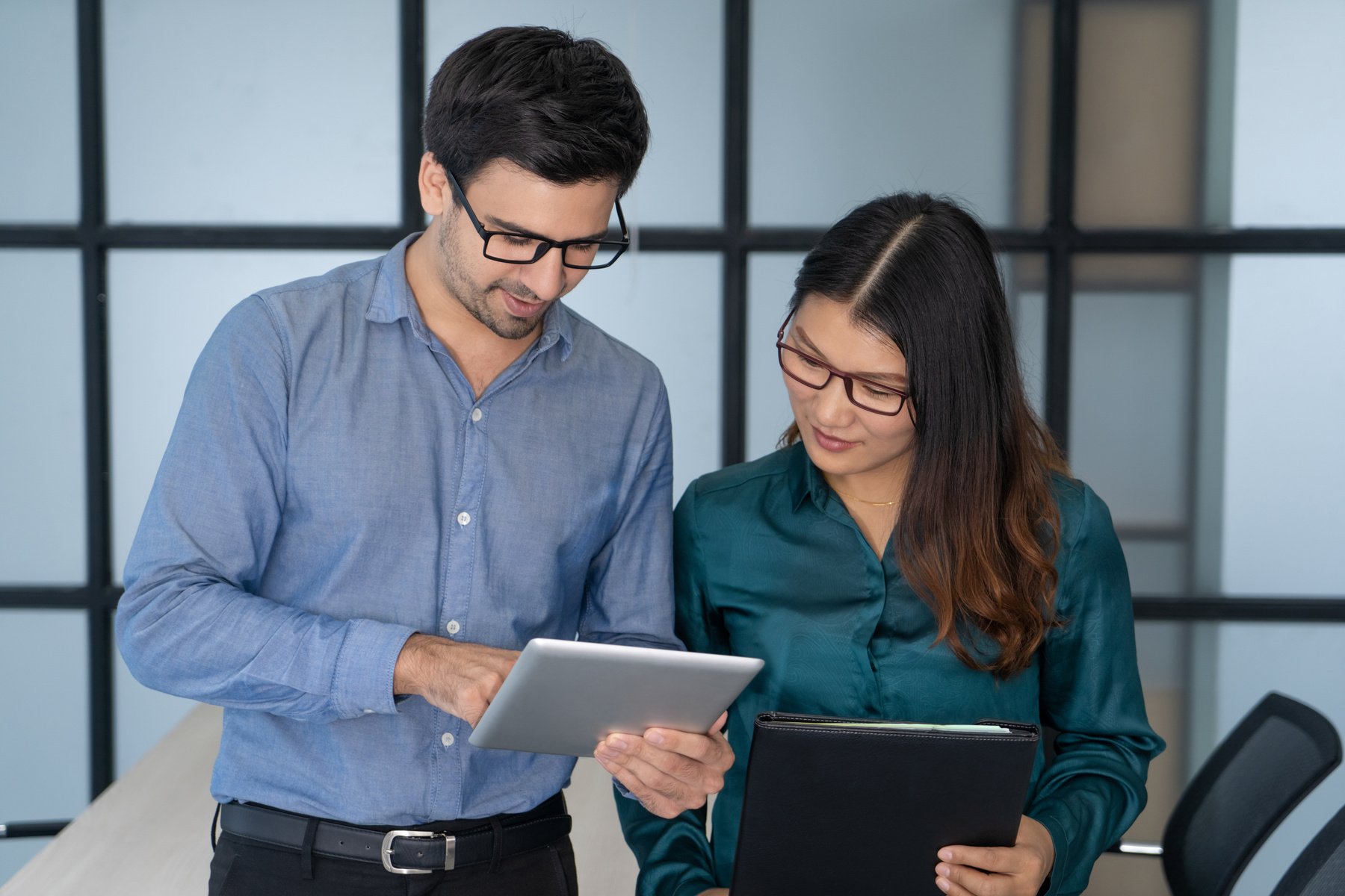 Caucasian Supervisor Helping New Asian Employee